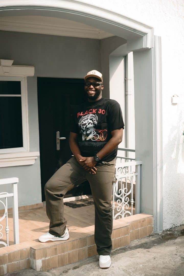 Woriidem laughing on a white porch