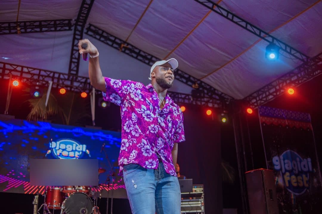 Woriidem with his arm outstretched mid-performance