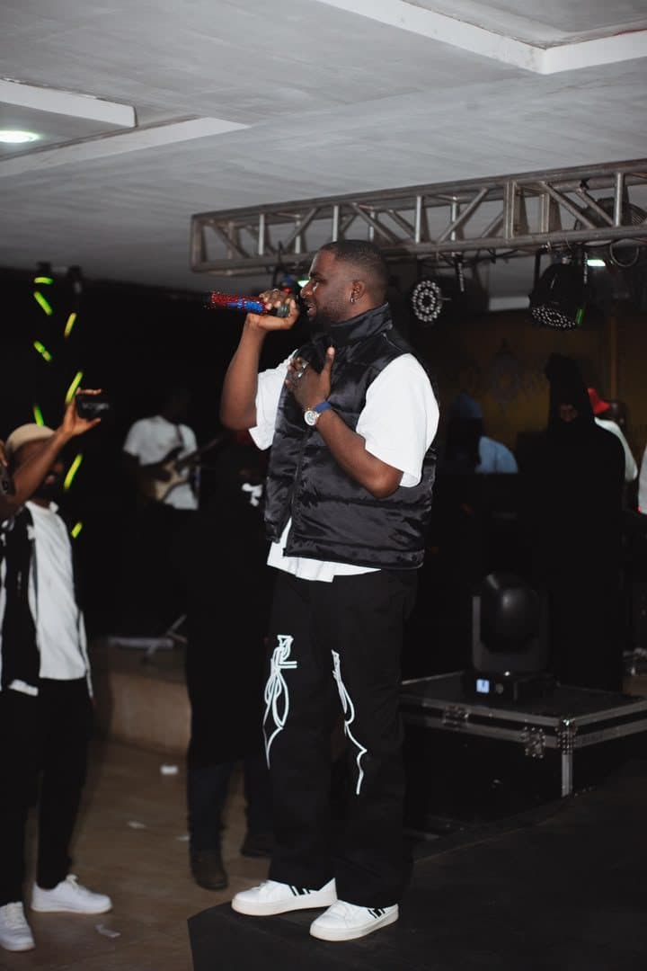 Woriidem singing with a hand on his chest